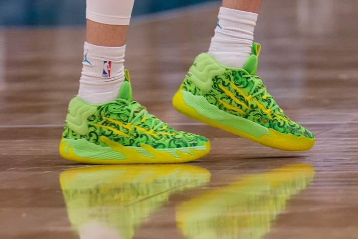 Charlotte Hornets guard LaMelo Ball's green and yellow PUMA shoes.